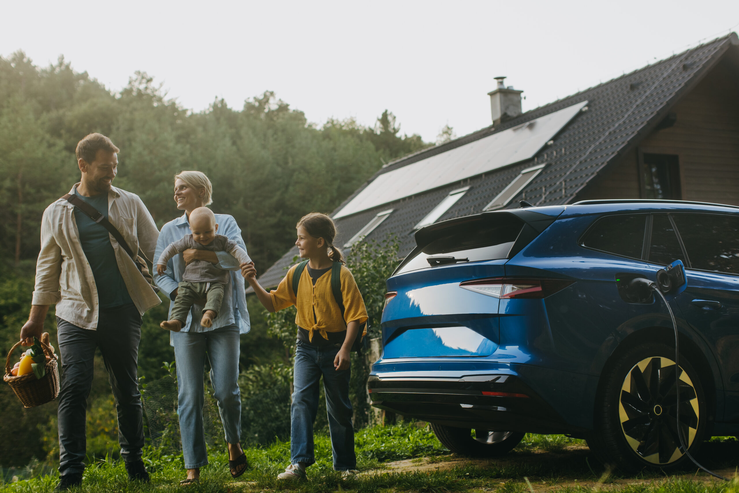 An image of a family and solar panels on the house